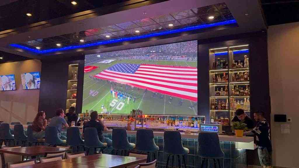 Dine-in area at Bru Sports Bar & Grill with cozy seating and sports screens
