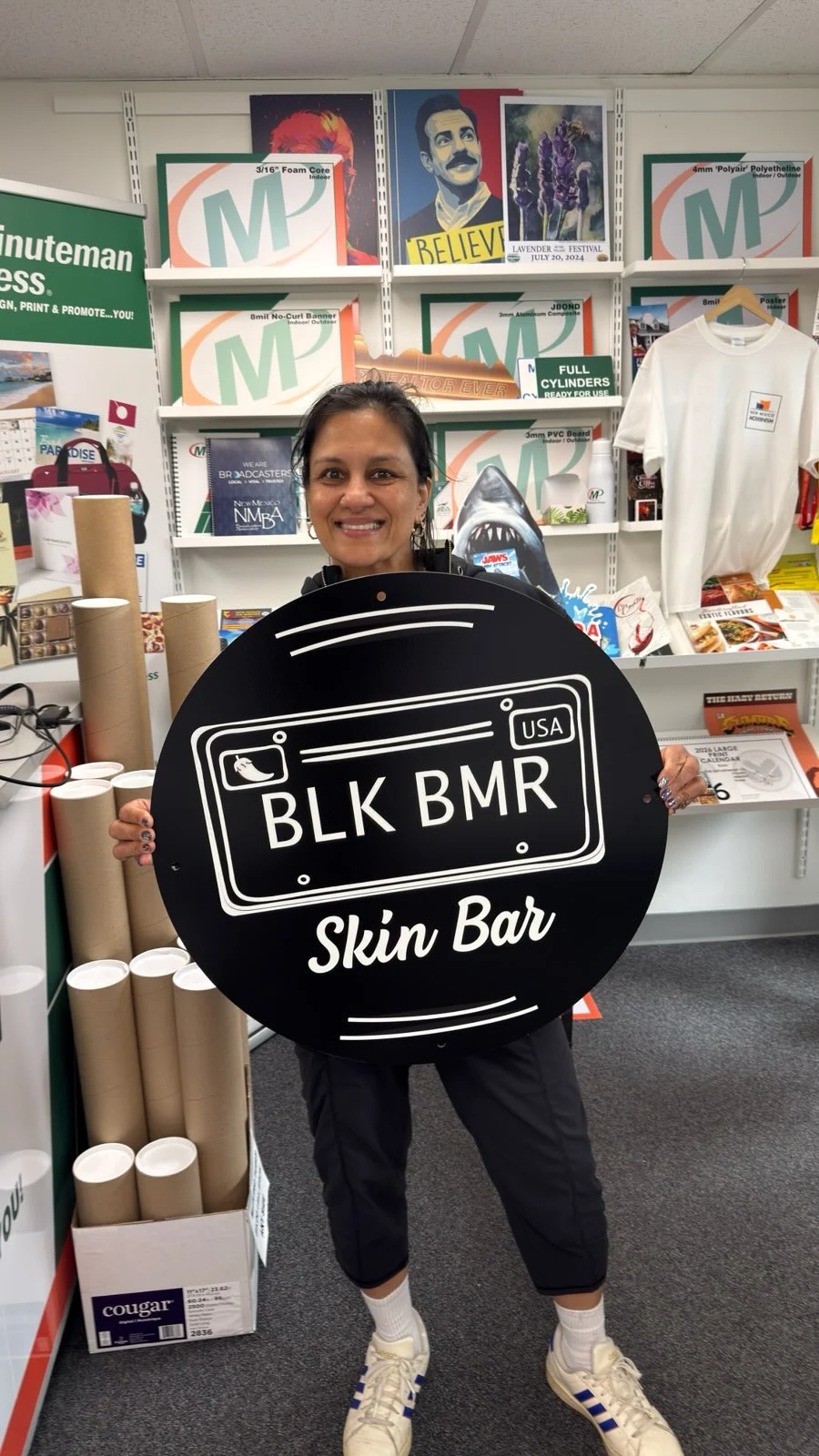 Seema Gupta holding the BLK BMR Skin Bar sign