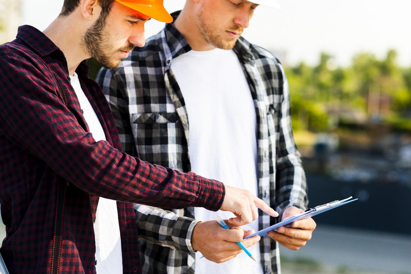 Facilities workers look at a checklist