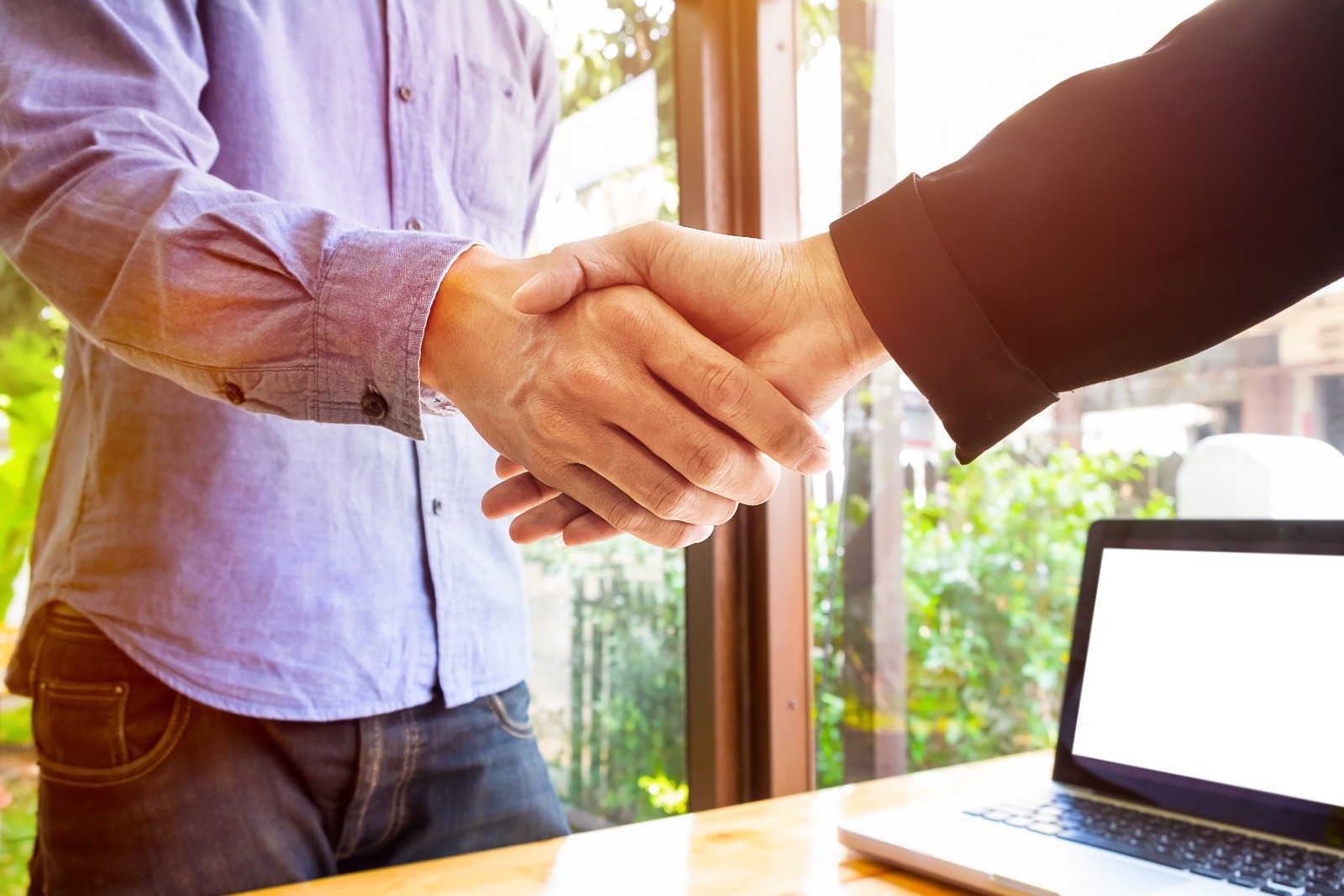 Two people shake hands